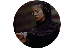 Woman wiht headphones on checking her smart wach